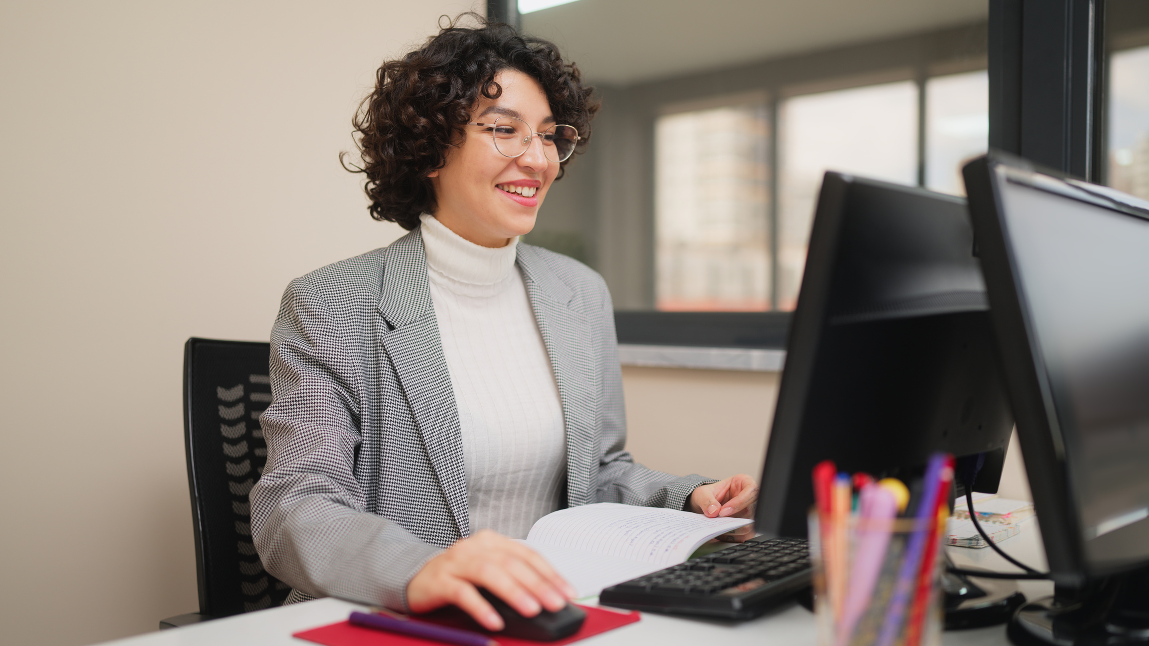 Female teacher working on computer